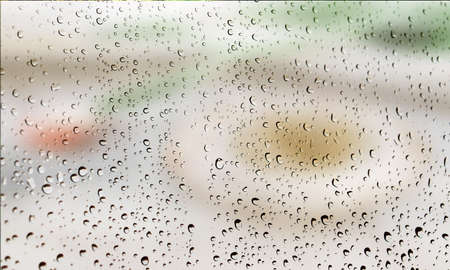 Background with rain drops close up. Rain drops on outdoor window, Closeup view transparent water drops on glass surface, humid water backdrop, blurred background with copy space for your textの写真素材