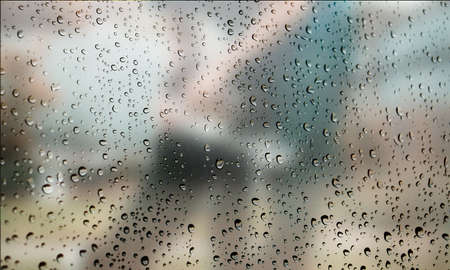 Background with rain drops close up. Rain drops on outdoor window, Closeup view transparent water drops on glass surface, humid water backdrop, blurred background with copy space for your textの写真素材