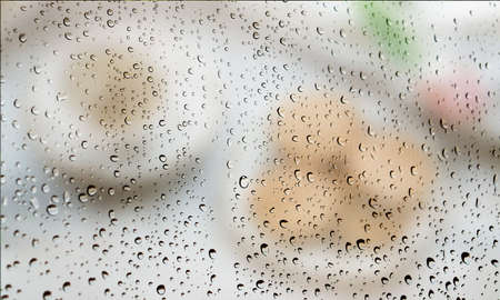 Background with rain drops close up. Rain drops on outdoor window, Closeup view transparent water drops on glass surface, humid water backdrop, blurred background with copy space for your textの写真素材