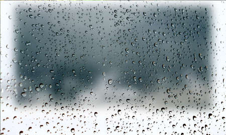 Background with rain drops close up. Rain drops on outdoor window, Closeup view transparent water drops on glass surface, humid water backdrop, blurred background with copy space for your textの写真素材
