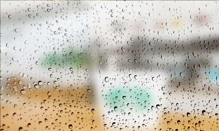 Background with rain drops close up. Rain drops on outdoor window, Closeup view transparent water drops on glass surface, humid water backdrop, blurred background with copy space for your textの写真素材