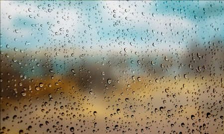 Background with rain drops close up. Rain drops on outdoor window, Closeup view transparent water drops on glass surface, humid water backdrop, blurred background with copy space for your textの写真素材