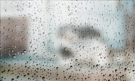 Background with rain drops close up. Rain drops on outdoor window, Closeup view transparent water drops on glass surface, humid water backdrop, blurred background with copy space for your textの写真素材