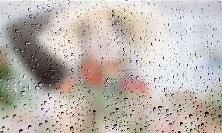 Background with rain drops close up. Rain drops on outdoor window, Closeup view transparent water drops on glass surface, humid water backdrop, blurred background with copy space for your textの写真素材