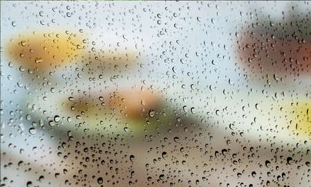 Background with rain drops close up. Rain drops on outdoor window, Closeup view transparent water drops on glass surface, humid water backdrop, blurred background with copy space for your textの写真素材