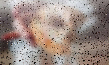 Background with rain drops close up. Rain drops on outdoor window, Closeup view transparent water drops on glass surface, humid water backdrop, blurred background with copy space for your textの写真素材