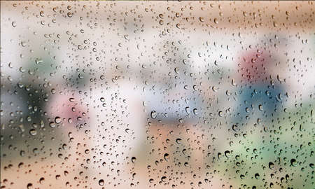 Background with rain drops close up. Rain drops on outdoor window, Closeup view transparent water drops on glass surface, humid water backdrop, blurred background with copy space for your textの写真素材