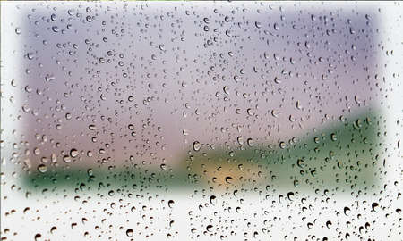 Background with rain drops close up. Rain drops on outdoor window, Closeup view transparent water drops on glass surface, humid water backdrop, blurred background with copy space for your textの写真素材