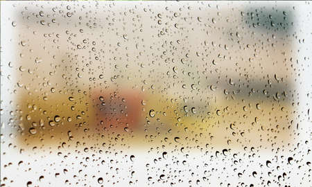 Background with rain drops close up. Rain drops on outdoor window, Closeup view transparent water drops on glass surface, humid water backdrop, blurred background with copy space for your textの写真素材