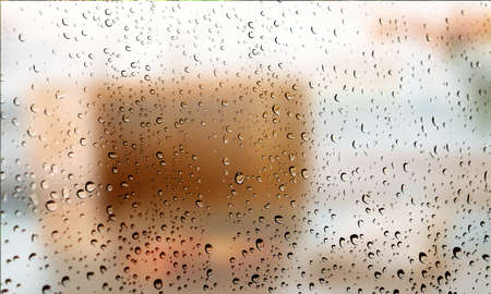 Background with rain drops close up. Rain drops on outdoor window, Closeup view transparent water drops on glass surface, humid water backdrop, blurred background with copy space for your textの写真素材