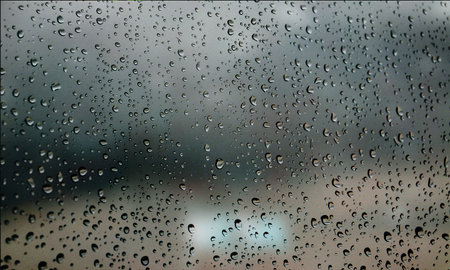 Background with rain drops close up. Rain drops on outdoor window, Closeup view transparent water drops on glass surface, humid water backdrop, blurred background with copy space for your textの写真素材