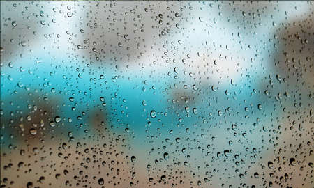 Background with rain drops close up. Rain drops on outdoor window, Closeup view transparent water drops on glass surface, humid water backdrop, blurred background with copy space for your textの写真素材