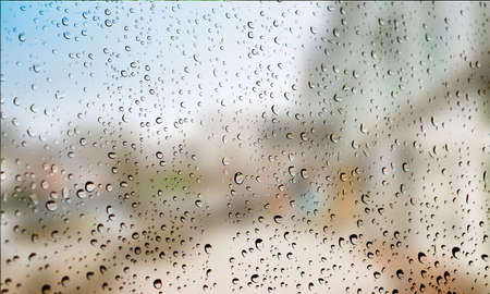 Background with rain drops close up. Rain drops on outdoor window, Closeup view transparent water drops on glass surface, humid water backdrop, blurred background with copy space for your textの写真素材