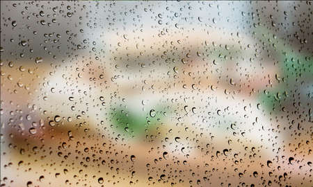 Background with rain drops close up. Rain drops on outdoor window, Closeup view transparent water drops on glass surface, humid water backdrop, blurred background with copy space for your textの写真素材