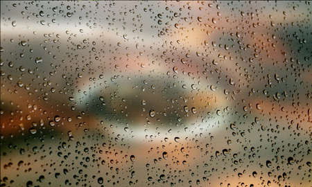 Background with rain drops close up. Rain drops on outdoor window, Closeup view transparent water drops on glass surface, humid water backdrop, blurred background with copy space for your textの写真素材