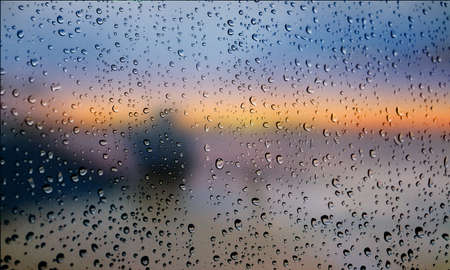 Background with rain drops close up. Rain drops on outdoor window, Closeup view transparent water drops on glass surface, humid water backdrop, blurred background with copy space for your textの写真素材