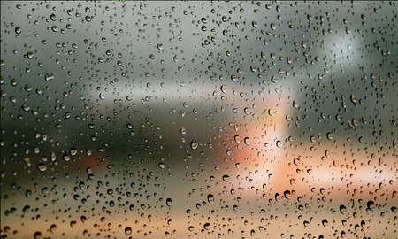 Background with rain drops close up. Rain drops on outdoor window, Closeup view transparent water drops on glass surface, humid water backdrop, blurred background with copy space for your textの写真素材