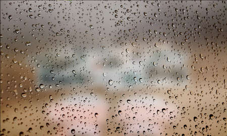 Background with rain drops close up. Rain drops on outdoor window, Closeup view transparent water drops on glass surface, humid water backdrop, blurred background with copy space for your textの写真素材