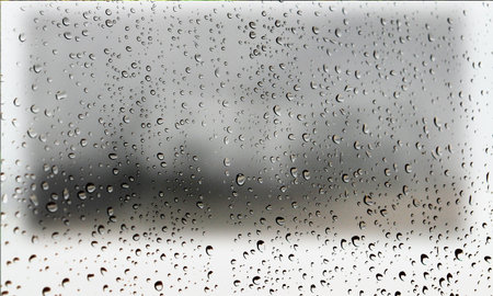 Background with rain drops close up. Rain drops on outdoor window, Closeup view transparent water drops on glass surface, humid water backdrop, blurred background with copy space for your textの写真素材