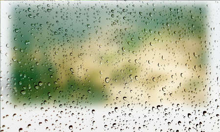 Background with rain drops close up. Rain drops on outdoor window, Closeup view transparent water drops on glass surface, humid water backdrop, blurred background with copy space for your textの写真素材