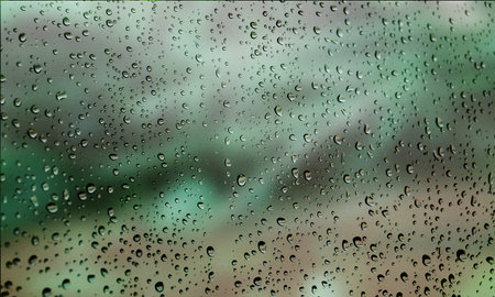 Background with rain drops close up. Rain drops on outdoor window, Closeup view transparent water drops on glass surface, humid water backdrop, blurred background with copy space for your textの写真素材