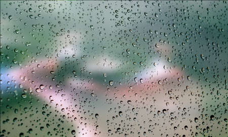 Background with rain drops close up. Rain drops on outdoor window, Closeup view transparent water drops on glass surface, humid water backdrop, blurred background with copy space for your textの写真素材
