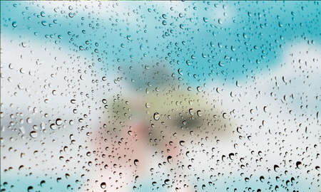 Background with rain drops close up. Rain drops on outdoor window, Closeup view transparent water drops on glass surface, humid water backdrop, blurred background with copy space for your textの写真素材