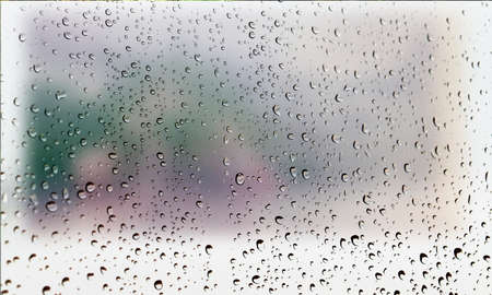 Background with rain drops close up. Rain drops on outdoor window, Closeup view transparent water drops on glass surface, humid water backdrop, blurred background with copy space for your textの写真素材
