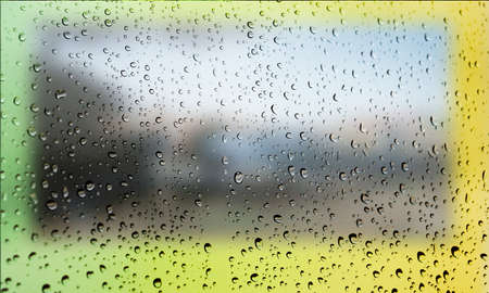 Background with rain drops close up. Rain drops on outdoor window, Closeup view transparent water drops on glass surface, humid water backdrop, blurred background with copy space for your textの写真素材