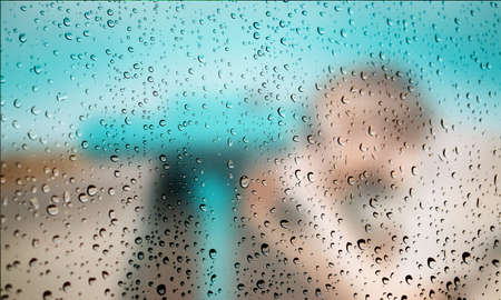 Background with rain drops close up. Rain drops on outdoor window, Closeup view transparent water drops on glass surface, humid water backdrop, blurred background with copy space for your textの写真素材