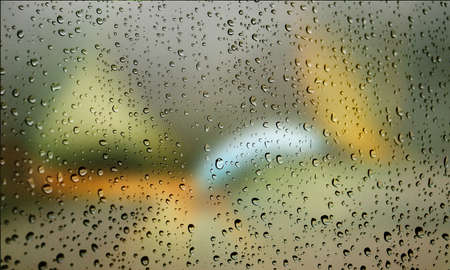 Background with rain drops close up. Rain drops on outdoor window, Closeup view transparent water drops on glass surface, humid water backdrop, blurred background with copy space for your textの写真素材