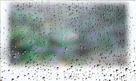 Background with rain drops close up. Rain drops on outdoor window, Closeup view transparent water drops on glass surface, humid water backdrop, blurred background with copy space for your textの写真素材