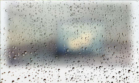 Background with rain drops close up. Rain drops on outdoor window, Closeup view transparent water drops on glass surface, humid water backdrop, blurred background with copy space for your textの写真素材