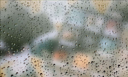 Background with rain drops close up. Rain drops on outdoor window, Closeup view transparent water drops on glass surface, humid water backdrop, blurred background with copy space for your textの写真素材