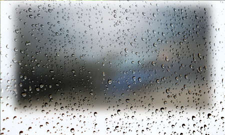 Background with rain drops close up. Rain drops on outdoor window, Closeup view transparent water drops on glass surface, humid water backdrop, blurred background with copy space for your textの写真素材