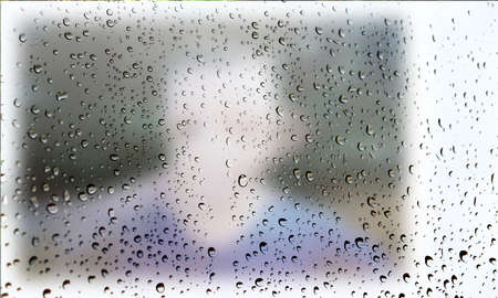Background with rain drops close up. Rain drops on outdoor window, Closeup view transparent water drops on glass surface, humid water backdrop, blurred background with copy space for your textの写真素材