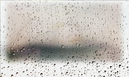 Background with rain drops close up. Rain drops on outdoor window, Closeup view transparent water drops on glass surface, humid water backdrop, blurred background with copy space for your textの写真素材