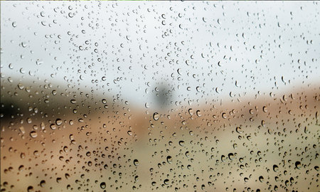 Background with rain drops close up. Rain drops on outdoor window, Closeup view transparent water drops on glass surface, humid water backdrop, blurred background with copy space for your textの写真素材