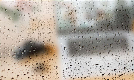 Background with rain drops close up. Rain drops on outdoor window, Closeup view transparent water drops on glass surface, humid water backdrop, blurred background with copy space for your textの写真素材