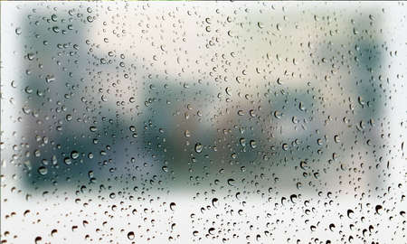 Background with rain drops close up. Rain drops on outdoor window, Closeup view transparent water drops on glass surface, humid water backdrop, blurred background with copy space for your textの写真素材