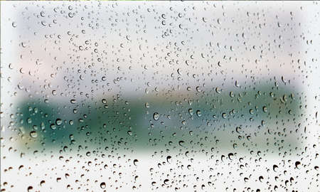 Background with rain drops close up. Rain drops on outdoor window, Closeup view transparent water drops on glass surface, humid water backdrop, blurred background with copy space for your textの写真素材