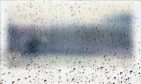 Background with rain drops close up. Rain drops on outdoor window, Closeup view transparent water drops on glass surface, humid water backdrop, blurred background with copy space for your textの写真素材
