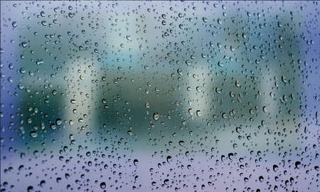 Background with rain drops close up. Rain drops on outdoor window, Closeup view transparent water drops on glass surface, humid water backdrop, blurred background with copy space for your textの写真素材