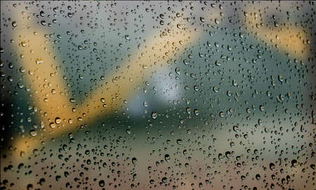 Background with rain drops close up. Rain drops on outdoor window, Closeup view transparent water drops on glass surface, humid water backdrop, blurred background with copy space for your textの写真素材