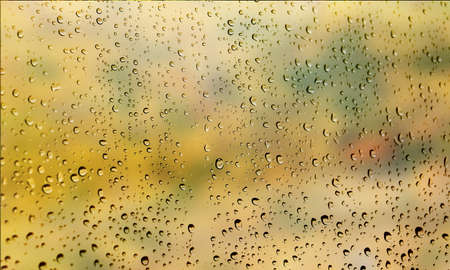Background with rain drops close up. Rain drops on outdoor window, Closeup view transparent water drops on glass surface, humid water backdrop, blurred background with copy space for your textの写真素材