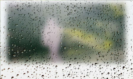 Background with rain drops close up. Rain drops on outdoor window, Closeup view transparent water drops on glass surface, humid water backdrop, blurred background with copy space for your textの写真素材