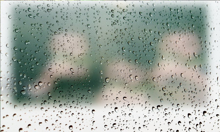Background with rain drops close up. Rain drops on outdoor window, Closeup view transparent water drops on glass surface, humid water backdrop, blurred background with copy space for your textの写真素材