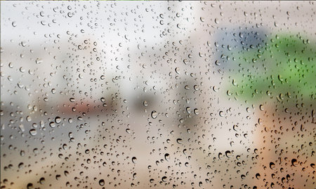 Background with rain drops close up. Rain drops on outdoor window, Closeup view transparent water drops on glass surface, humid water backdrop, blurred background with copy space for your textの写真素材