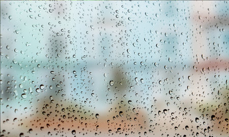 Background with rain drops close up. Rain drops on outdoor window, Closeup view transparent water drops on glass surface, humid water backdrop, blurred background with copy space for your textの写真素材