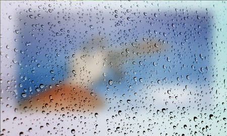 Background with rain drops close up. Rain drops on outdoor window, Closeup view transparent water drops on glass surface, humid water backdrop, blurred background with copy space for your textの写真素材